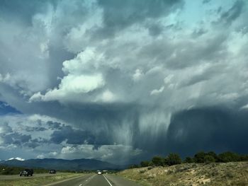 Scenic view of storm clouds over landscape