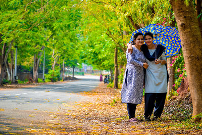 Woman standing in park during autumn