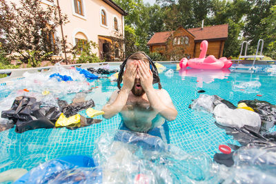 High angle view of shirtless man in swimming pool