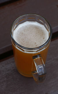 High angle view of beer glass on wooden table