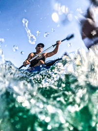 Young man swimming in sea