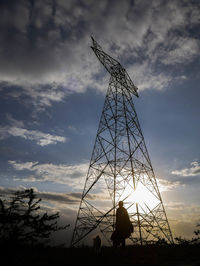 Low angle view of silhouette man standing against sky