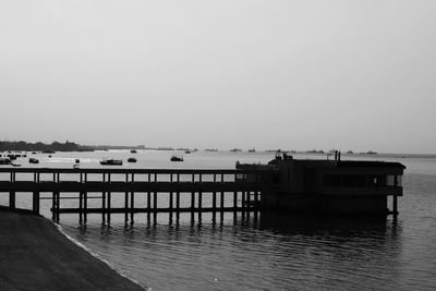 Pier on sea against clear sky