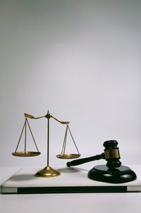 Close-up of clock on table against white background