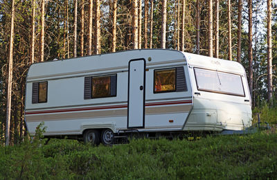 Large caravan parked in the forest