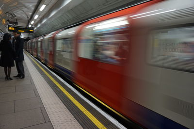 Blurred motion of train at railroad station