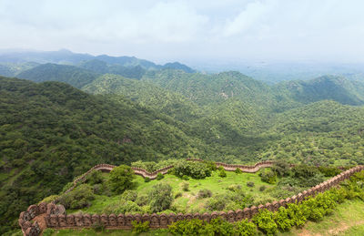 High angle view of wall on green mountains