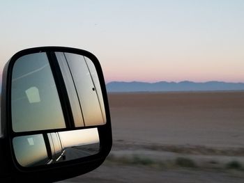 Reflection on side-view mirror of car