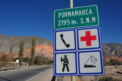 Road sign against clear blue sky