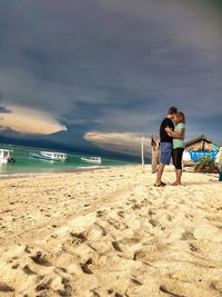 Full length of woman on beach against sky