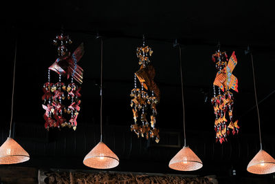 Low angle view of decoration hanging against black background