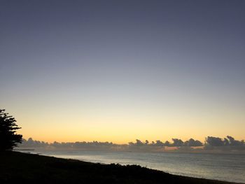 Scenic view of sea against clear sky during sunset