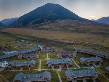 High angle view of townscape and mountains against sky