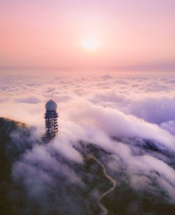 High angle view of communications tower on mountain in foggy weather