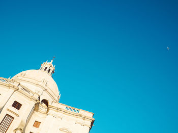 Low angle view of building against clear blue sky