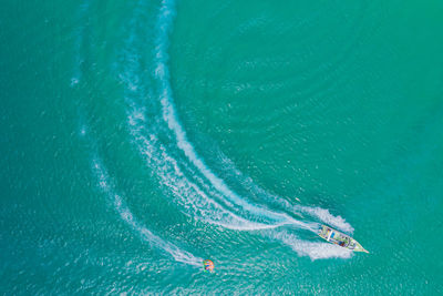 Aerial drone photo of extreme powerboat donut water-sports cruising in high speed turquoise bay