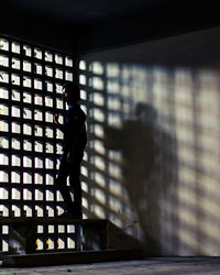 Man standing at window in room