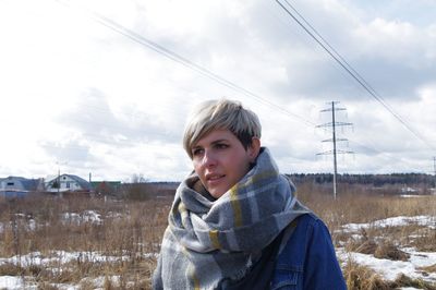 Portrait of woman on snow against sky