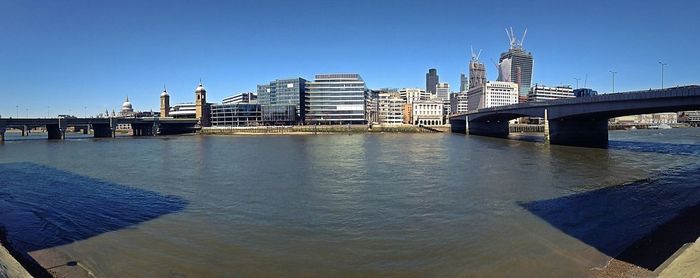 Bridge over river with city in background