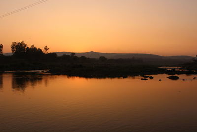 Scenic view of lake against sky during sunset