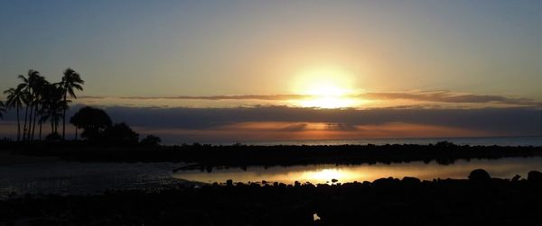 Scenic view of lake against sky during sunset
