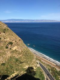 High angle view of road by sea against clear sky