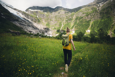Woman hiking through meadow