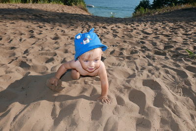 High angle view of boy on sand at beach