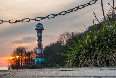 Lighthouse against sky at sunset