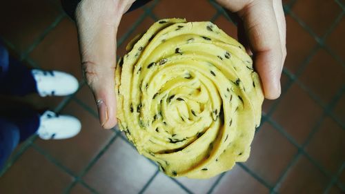 High angle view of a hand holding a cookie