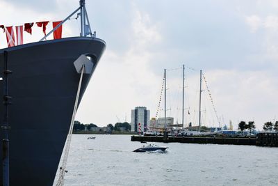 Commercial dock by sea against sky