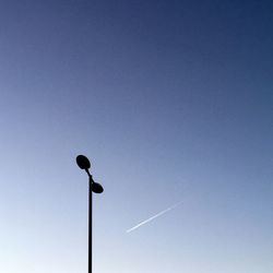 Low angle view of street light against blue sky