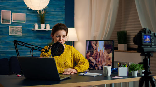 Woman working on table at home