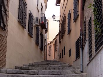 Low angle view of steps amidst buildings