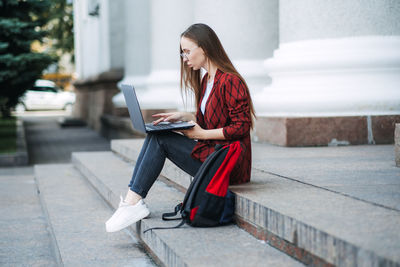 Online jobs for college students. young woman student girl searching job with laptop outdoors