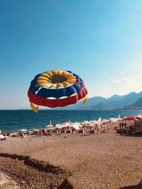 Umbrellas on beach against sky