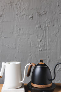 Close-up of coffee cup on table against white wall