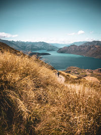 Scenic view of lake with mountains against sky