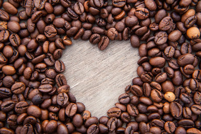 Close-up of heart shape roasted coffee beans on table