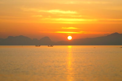 Scenic view of sea against orange sky