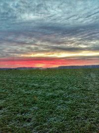 Scenic view of field against dramatic sky