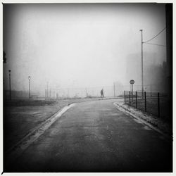 Empty road along trees