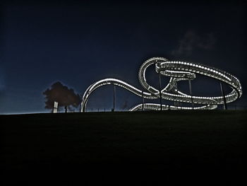 Low angle view of illuminated tiger and turtle against sky