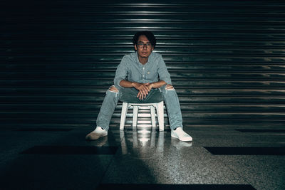 Portrait of young man sitting on seat