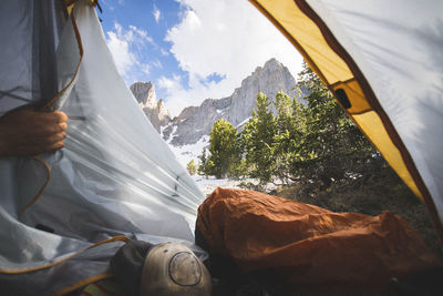 Cropped hand of hiker in tent at grand teton national park