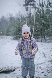 Cute girl standing in snow
