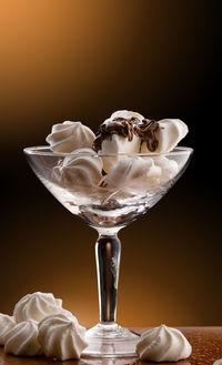 Close-up of ice cream on table against black background