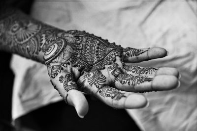 High angle view of henna tattoo on hand