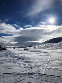 Scenic view of snow covered landscape against sky