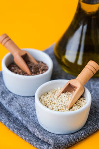 Sesame and flax seeds wooden spoons with oil in glass bottle. healthy food concept. vegan keto diet.